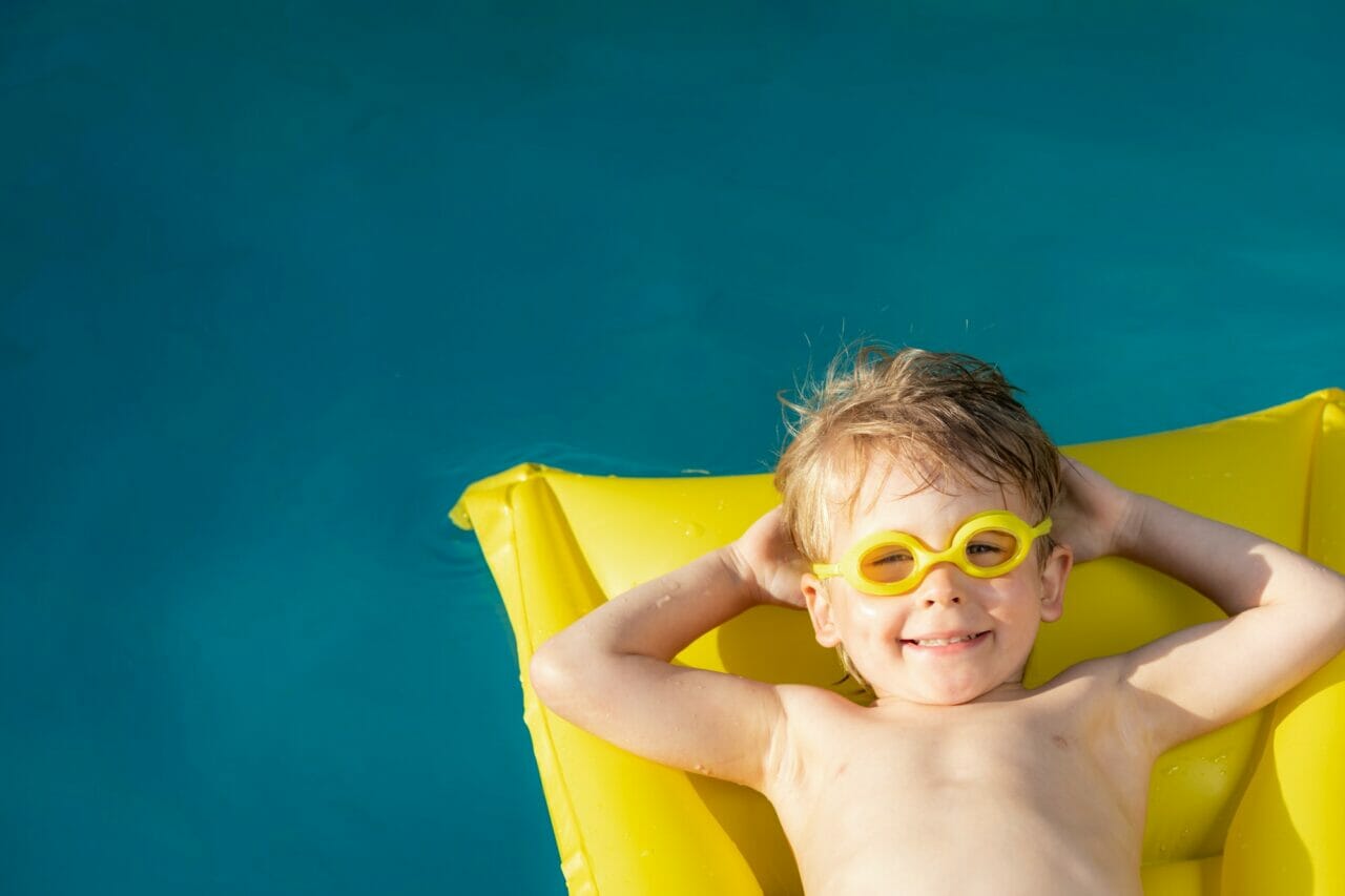 happy child swimming on summer vacation