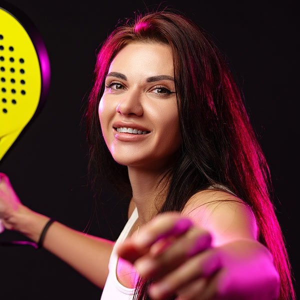 smiling woman prepares to serve