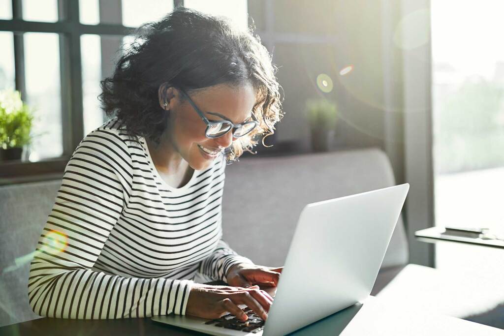 smiling young african woman working online with a 3m7w2sx